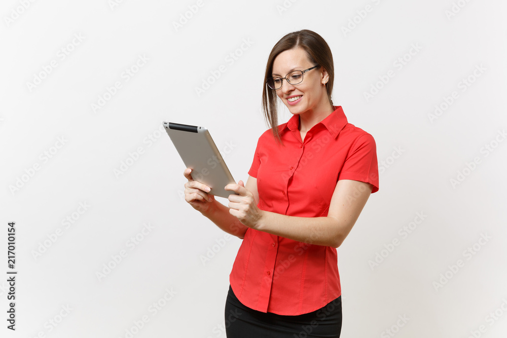 Portrait of beautiful young business teacher woman user in red shirt, glasses working typing on tablet pc computer isolated on white background. Education or teaching in high school university concept Portrait of beautiful young business teacher woman user in red shirt, glasses working typing on tablet pc computer isolated on white background. Education or teaching in high school university concept