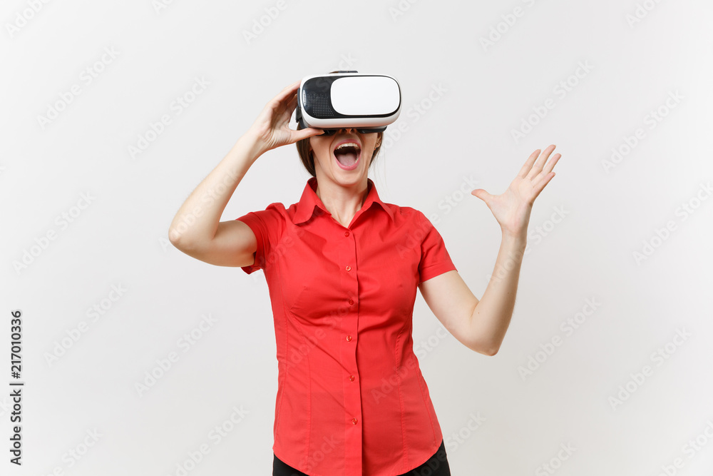 Portrait of young smart business woman in red shirt, black skirt in headset of virtual reality on head isolated on white background. Education or teaching of future in high school university concept. Portrait of young smart business woman in red shirt, black skirt in headset of virtual reality on head isolated on white background. Education or teaching of future in high school university concept.
