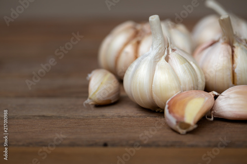 Garlic and cloves upper right corner on wooden background