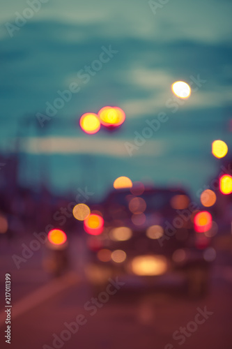Blur traffic road with colorful bokeh light and old building town abstract background,retro tone.