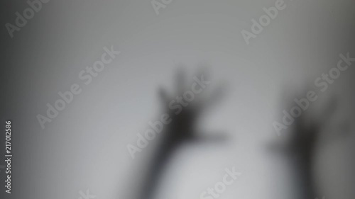 Shadowy figure behind glass / fear, panic concept