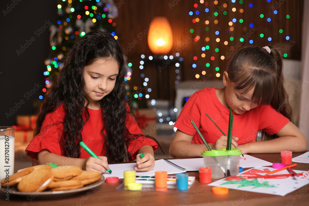 Fototapeta premium Little children drawing pictures at home. Christmas celebration
