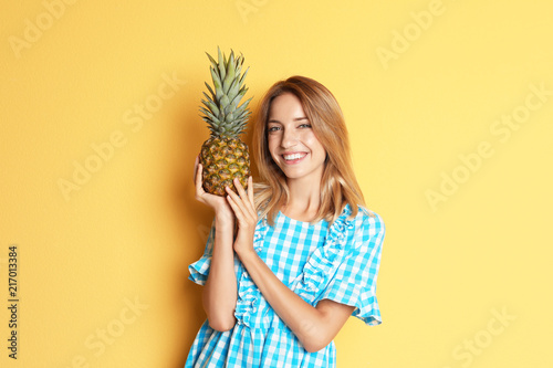 Happy slim woman with pineapple on color background. Weight loss diet
