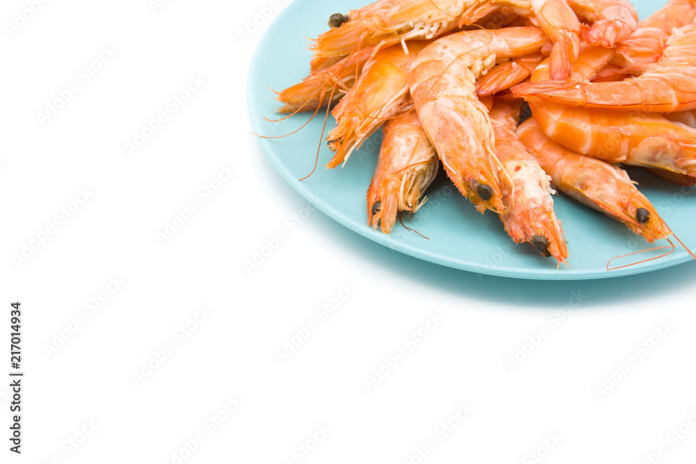 Grilled shrimps on blue plate isolated on white background. Copyspace