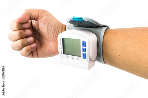 Arm of man who is examining their health with wrist Blood Pressure Monitor isolated
