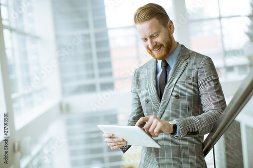 Confident businessman using...