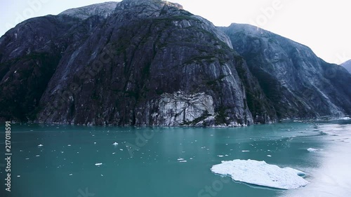 The Rock and an iceberg in Tracy Arm Fjord near Juneau, Alaska. Untamed, natural wilderness and wildlife with incredible landscape. Slow motion. photo