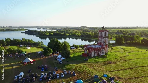 BELARUS, BELAYA CERKOV - August 04, 2018: International open air festival SPRAVA in Belarus. Aerial panoramic view with the ruins of the old church at sunset. 4K-video. photo