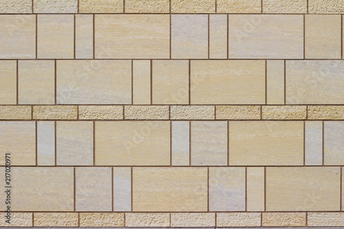 Modern stone tile wall background with a marble looking beige stones arranged in a stained glass style