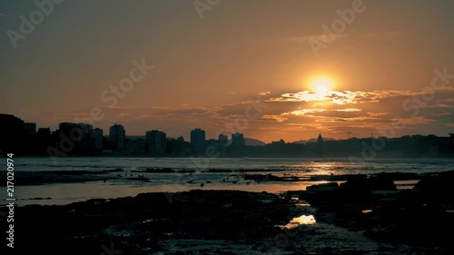 Amazing golden light city beach sunset at Atlantic coast, with a lot of calmness, beautifull orange sun and dramatic landscape