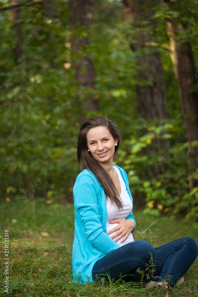Beautiful portrait of pregnant woman in the forest Beautiful portrait of pregnant woman in the forest