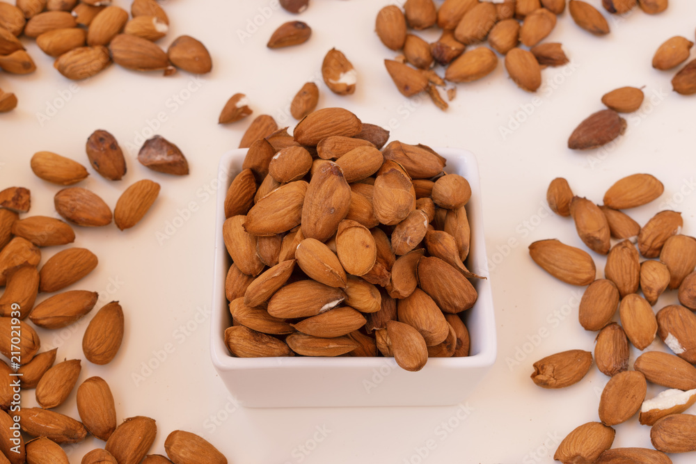 Raw almonds on a white plate. Raw almonds on a white plate.