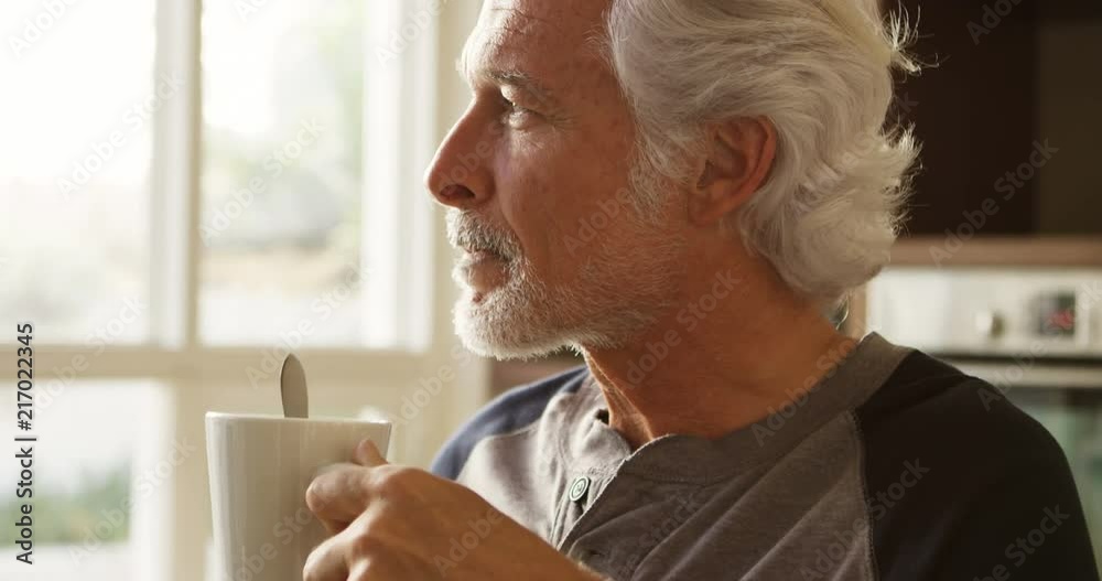 Senior man having coffee in kitchen at home 4k Senior man having coffee in kitchen at home 4k