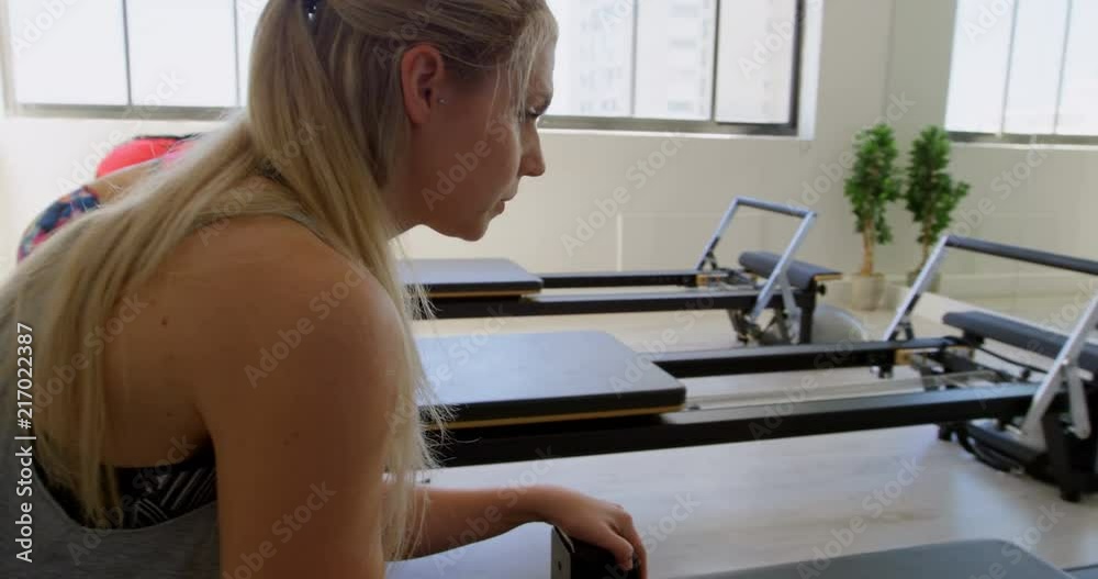 Women doing exercise with rowing machine 4k Women doing exercise with rowing machine 4k