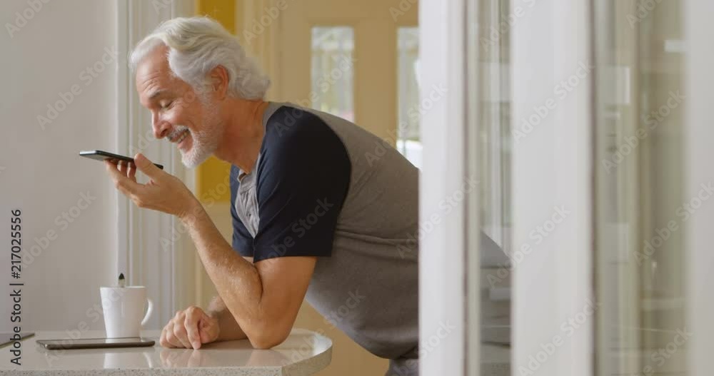Senior man talking on mobile phone at home 4k Senior man talking on mobile phone at home 4k