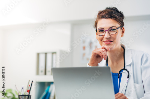 Portrait of Woman Doctor at her Medical Office writing Prescription