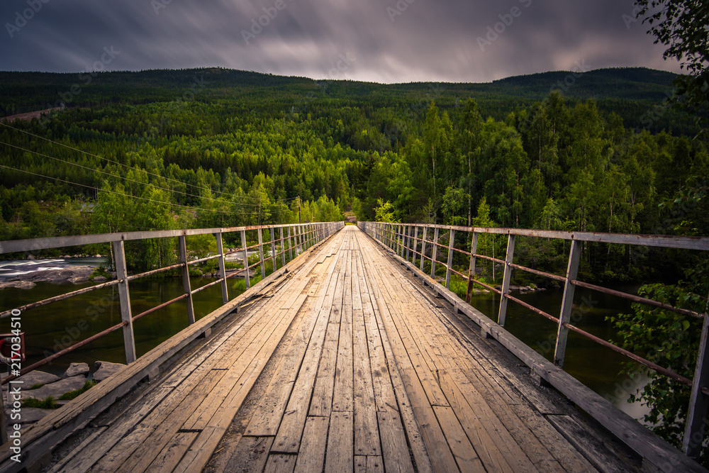 A bridge crossing a river in the countryside of Norway A bridge crossing a river in the countryside of Norway