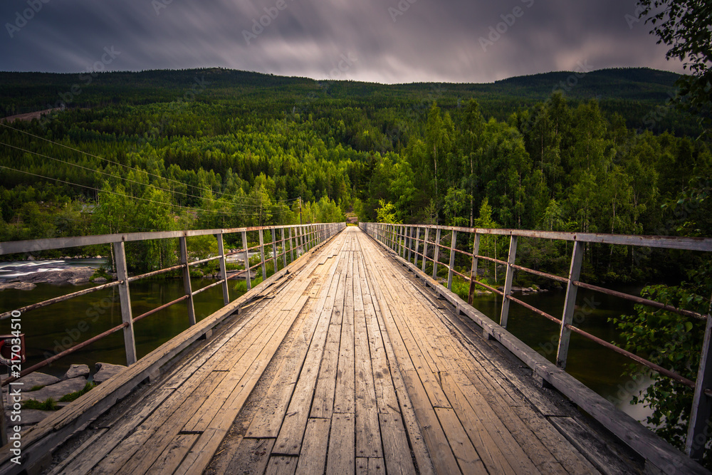 A bridge crossing a river in the countryside of Norway