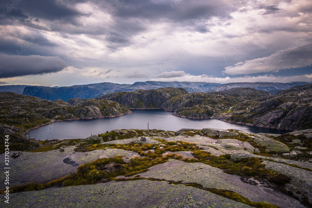 Norway- July 31, 2018: Traveler in the landscape near the Kjerag rock, Norway