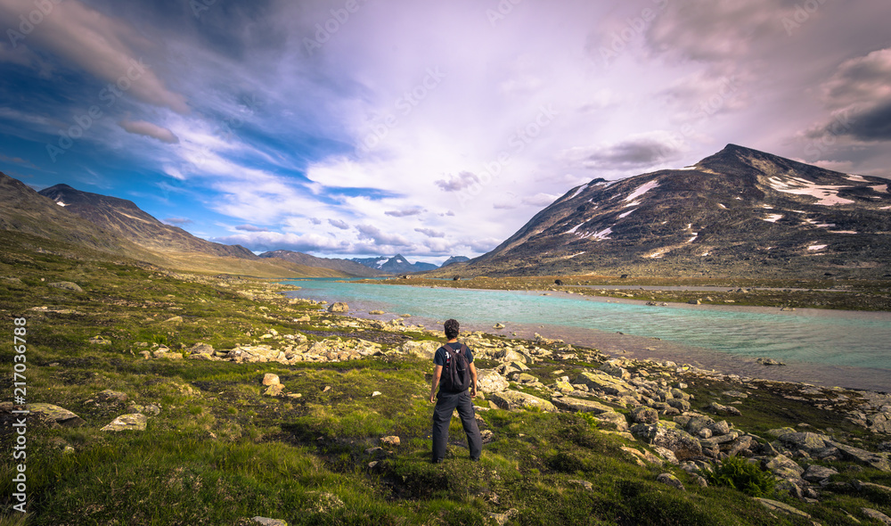 Jotunheimen National Park - July 29, 2018: Traveler in the wild mountain landscape in the Jotunheimen National Park, Norway