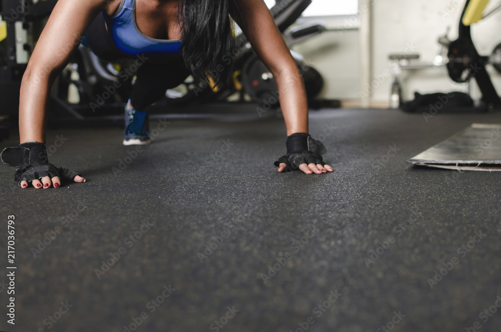 Woman doing push-up on one leg Woman doing push-up on one leg