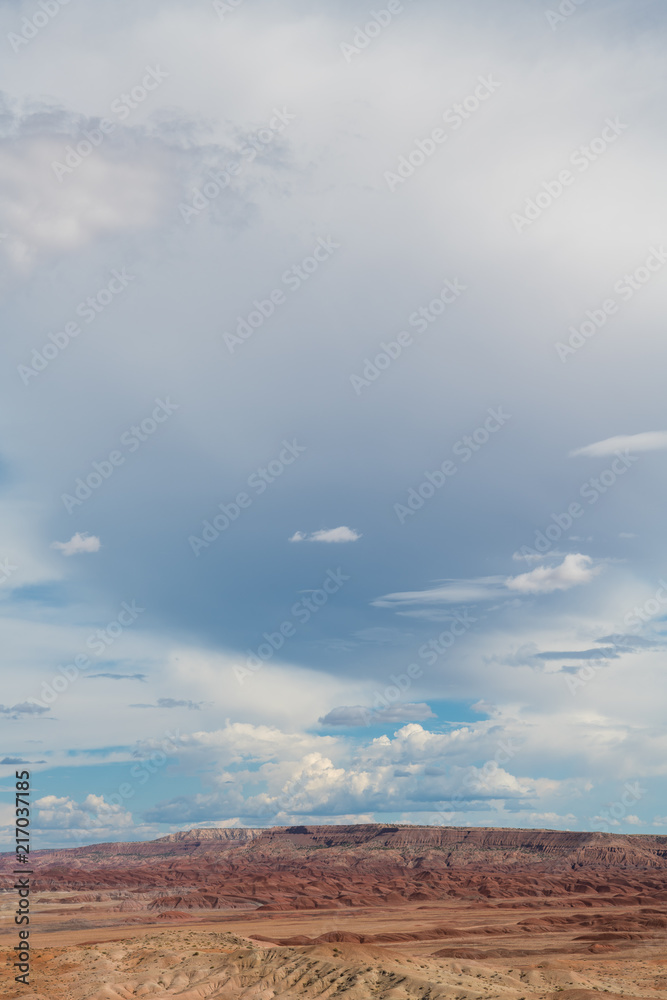 View of the vast colorful desert landscape and dramatic clouds and sky in the American Southwest in northeastern Arizona