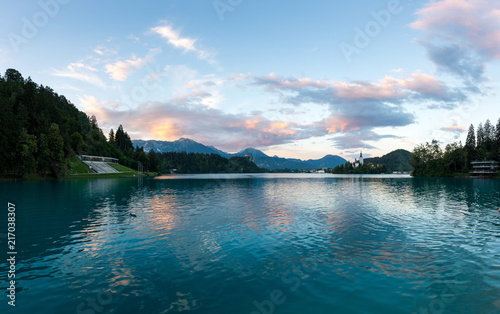 Mystic and magic sunset above the Bled lake  Slovenia. Beautiful magic purple colors and peaceful lake with church on the island. Magic sunset above the Alps.