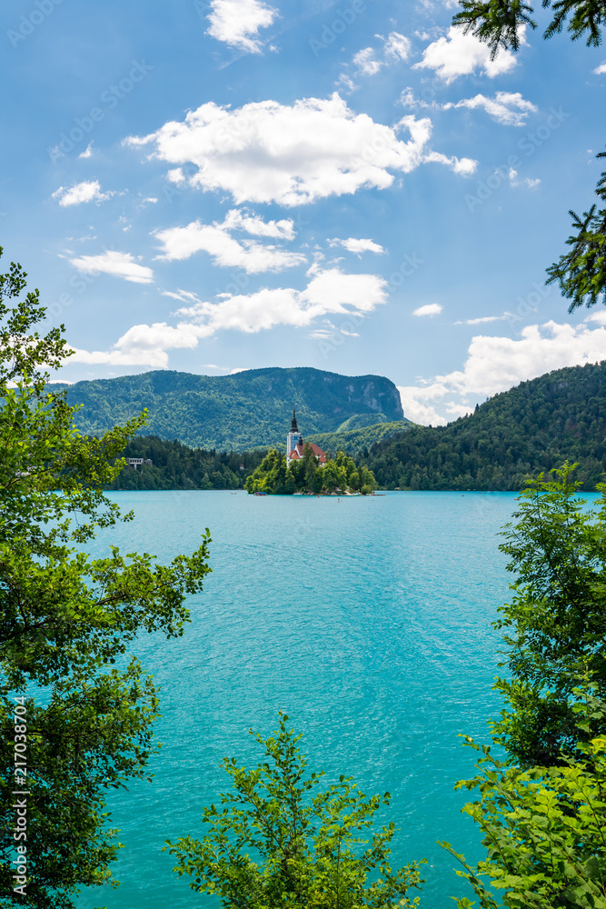 Bled lake, Slovenia. Pure blue water and swimming peoples in the lake, near church on the island on middle of the lake