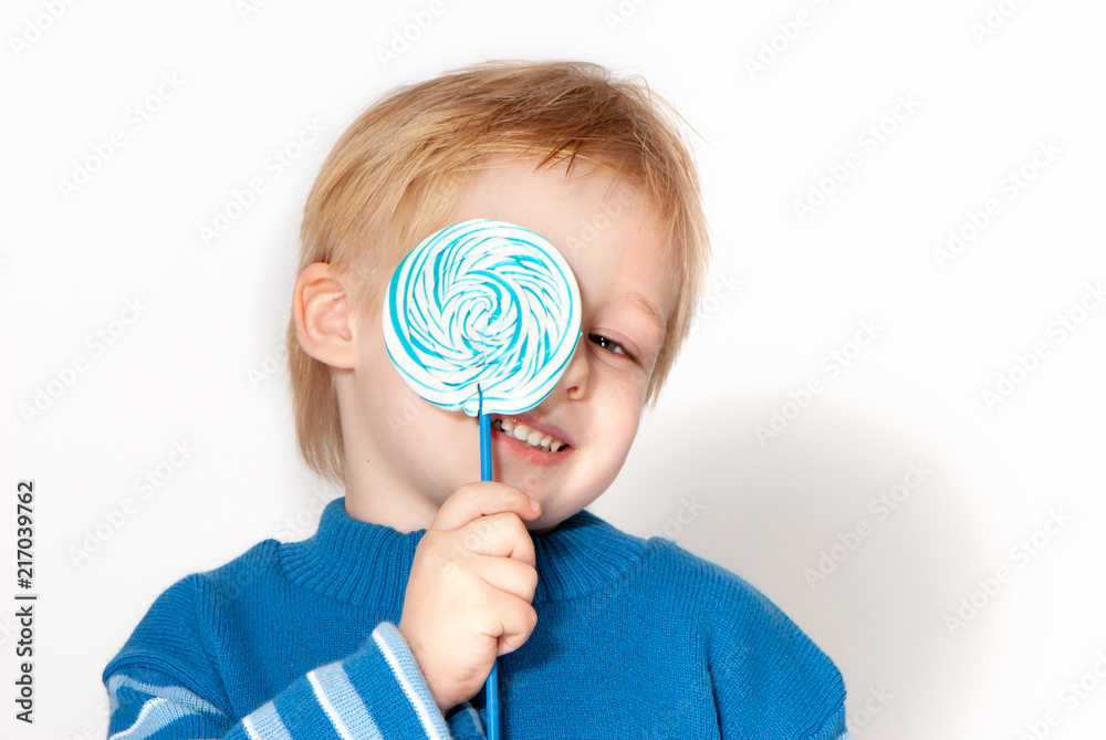 Happy boy with sugar candies in hands Happy boy with sugar candies in hands