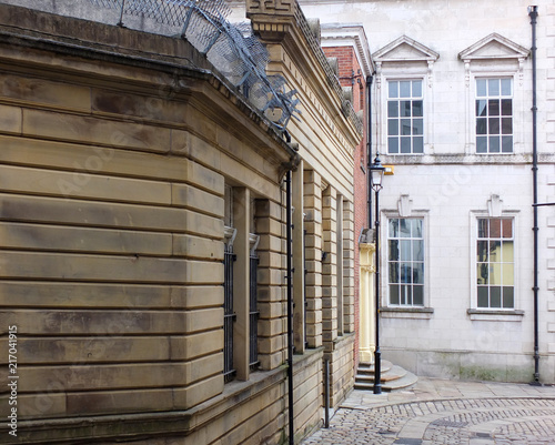 old buildings on a cobbled street in rochdale town centre looking downhill on a sharp corner