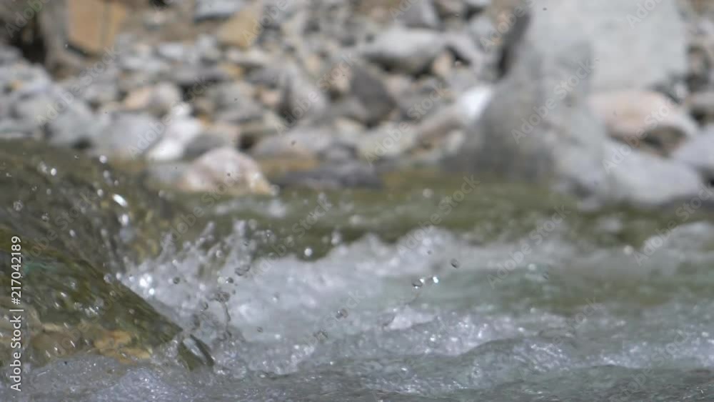 Beautiful water in a mountain river in slow motion video. Shooting speed 180fps, slow motion. Live shooting of the most beautiful nature river mountain water. The camera is not static. Beautiful water in a mountain river in slow motion video. Shooting speed 180fps, slow motion. Live shooting of the most beautiful nature river mountain water. The camera is not static.
