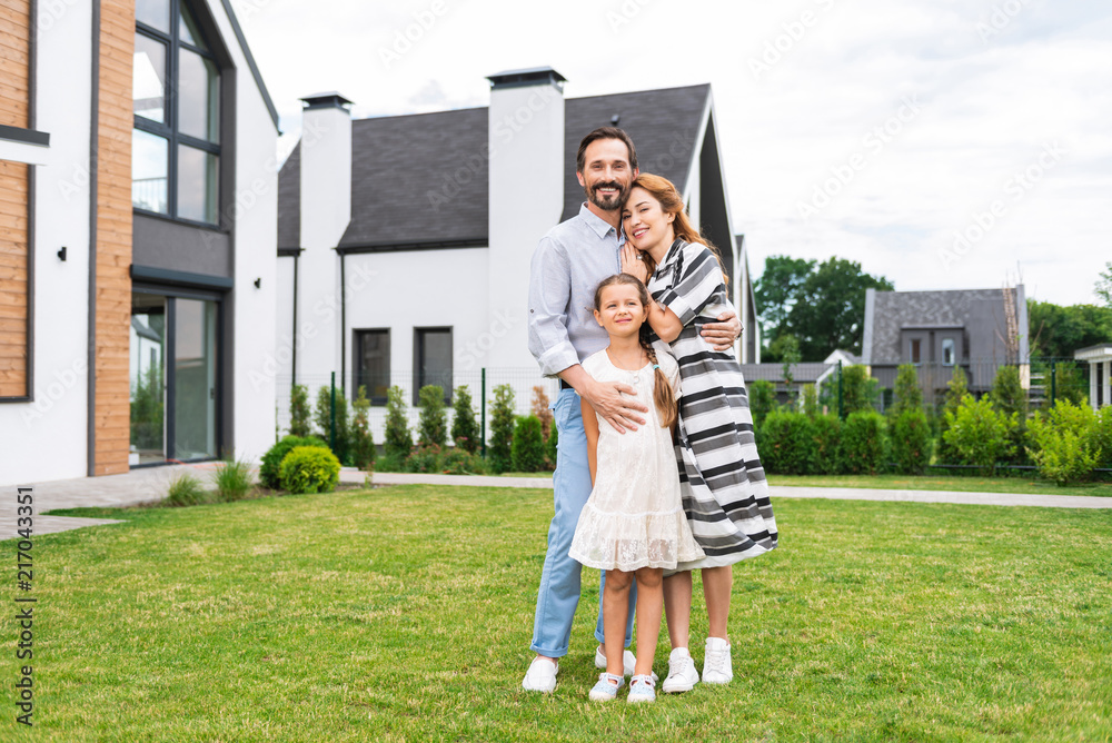 Obraz premium Great mood. Delighted positive family standing together while enjoying their weekend