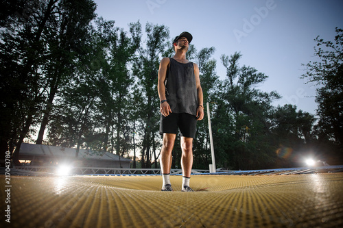 Young man standing on the yellow trampoline