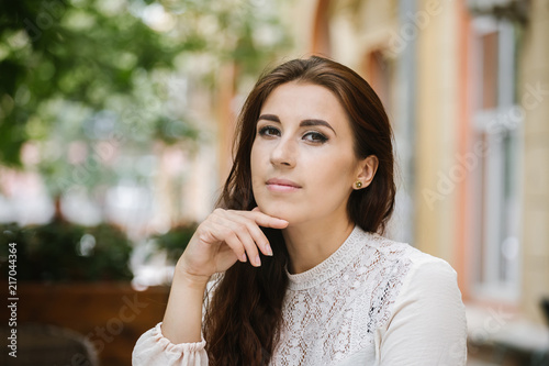 Portrait of a business woman sitting in a city outdoor cafe