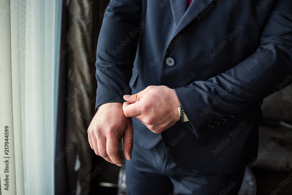 Businessman wears a jacket,male hands closeup,groom getting ready in the morning before wedding ceremony Businessman wears a jacket,male hands closeup,groom getting ready in the morning before wedding ceremony