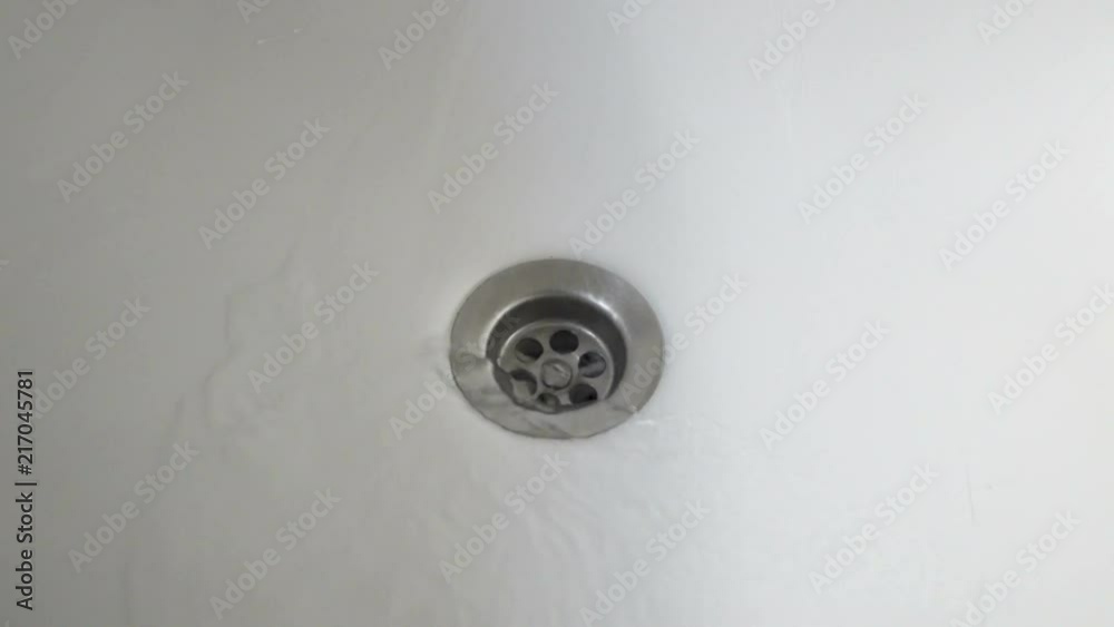 Water going in a drain until it disappears. Water going in a drain until it disappears.