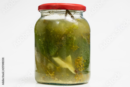 Vegetables in jars prepared for the winter. Tasty preserves on a white kitchen table.
