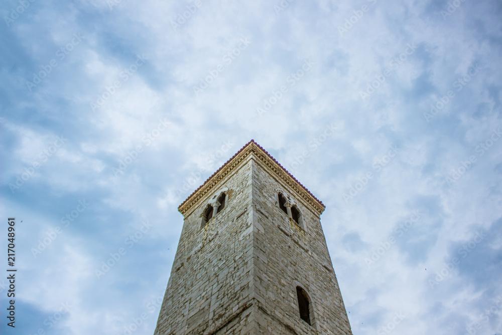 old medieval tower architecture concept on rainy cloud sky background with empty space for copy or text