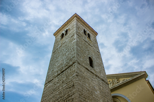 old medieval tower architecture concept on rainy cloud sky background with empty space for copy or text