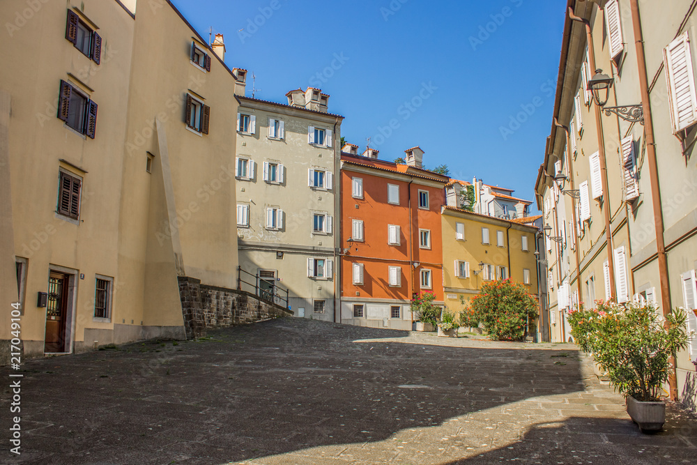 italian colorful buildings facade in empty small cozy yard in summer bright contrast day time