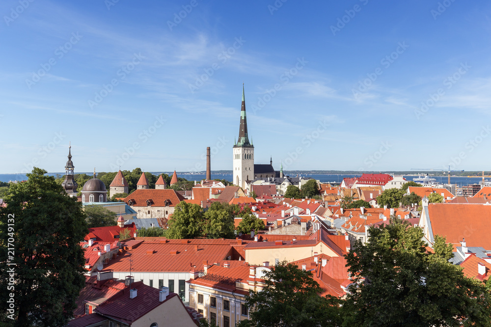 Old buildings and St. Olaf's (or Olav's) church at the Old Town in Tallinn, Estonia, viewed from above on a sunny day in the summer.
