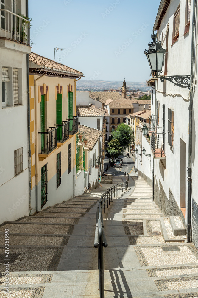 White buildings and narrow streets in the moorish neighbourhood in Granada, Spain