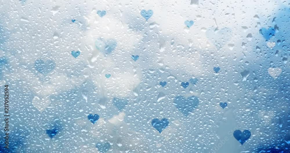 Water drops on window with blue colored heart signs and clouds time lapse background. Water drops on window with blue colored heart signs and clouds time lapse background.