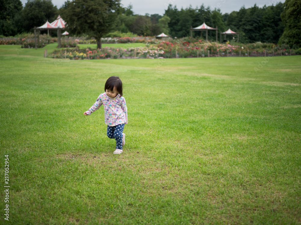 baby girl running in Summer forest park