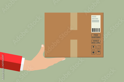 A delivery of a fragile package right to the doors. A box with a fragile content in a cardboard with a barcode.