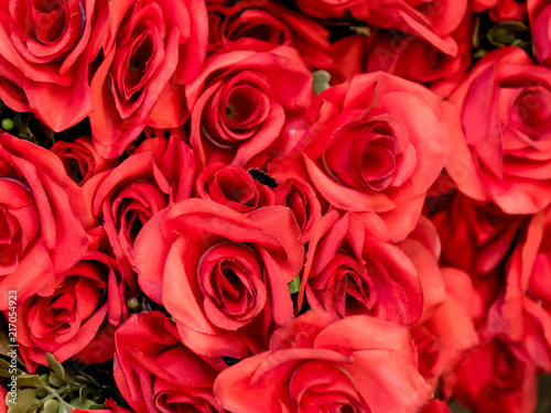 A bouquet of artificial red roses closeup background. Selective focus. © ersoy