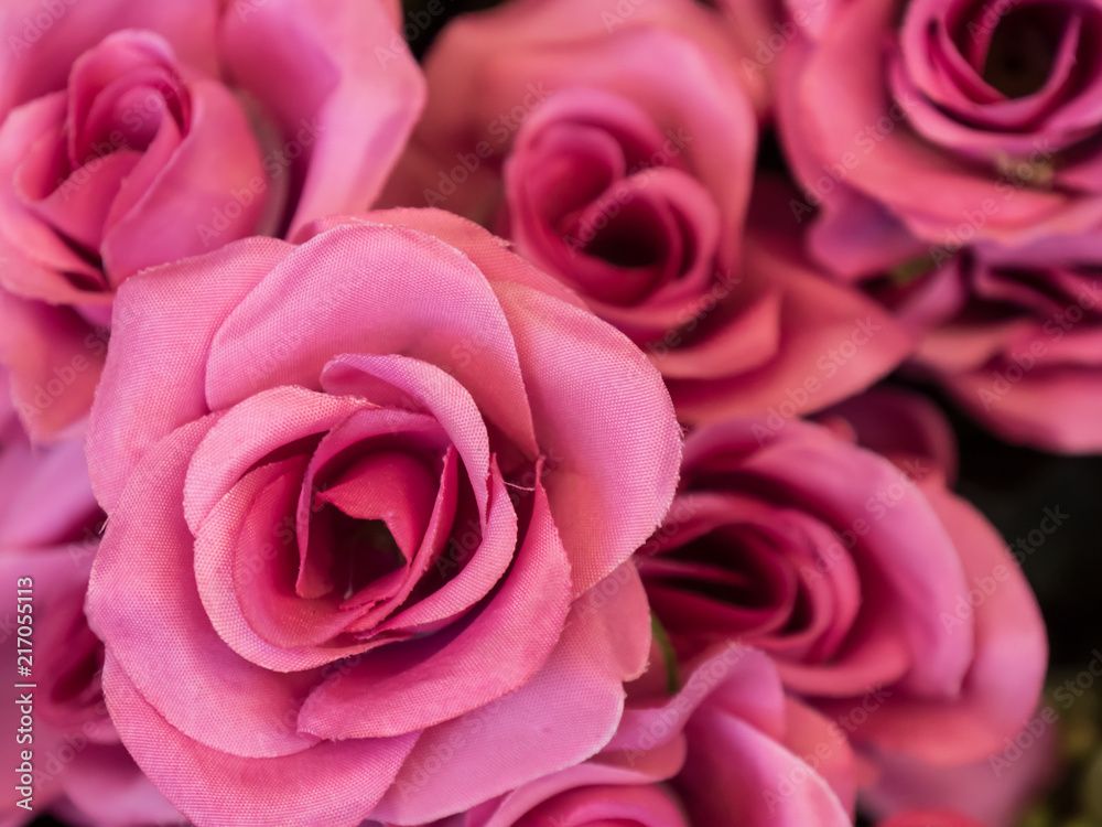 A bouquet of artificial pink roses closeup background. Selective focus. A bouquet of artificial pink roses closeup background. Selective focus.