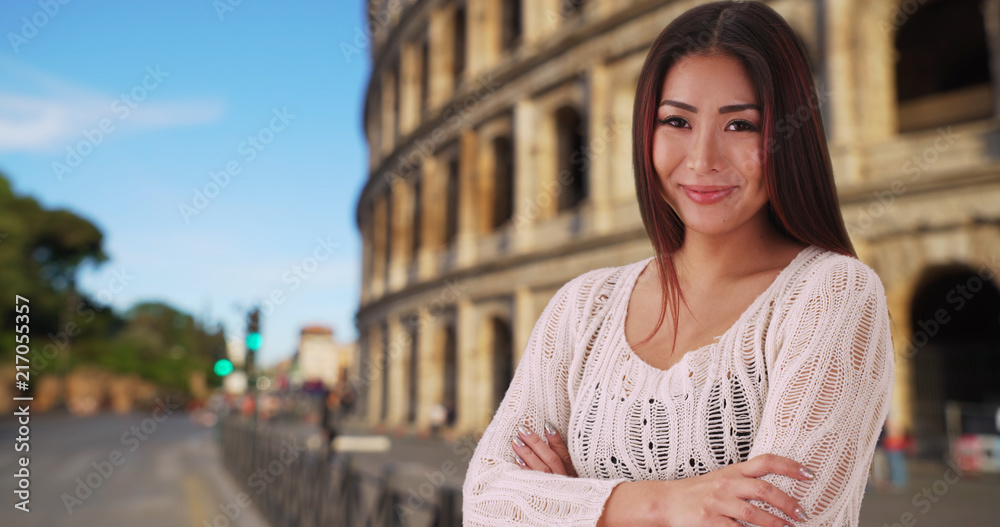 Casual portrait of pretty Japanese female smiling and laughing near Coliseum