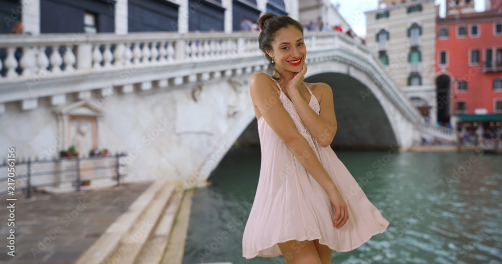Sexy Latina tourist in sundress standing near Grand Canal Venice Italy