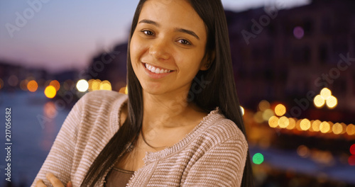 Happy laughing Latin female standing by Grand Canal at night © rocketclips